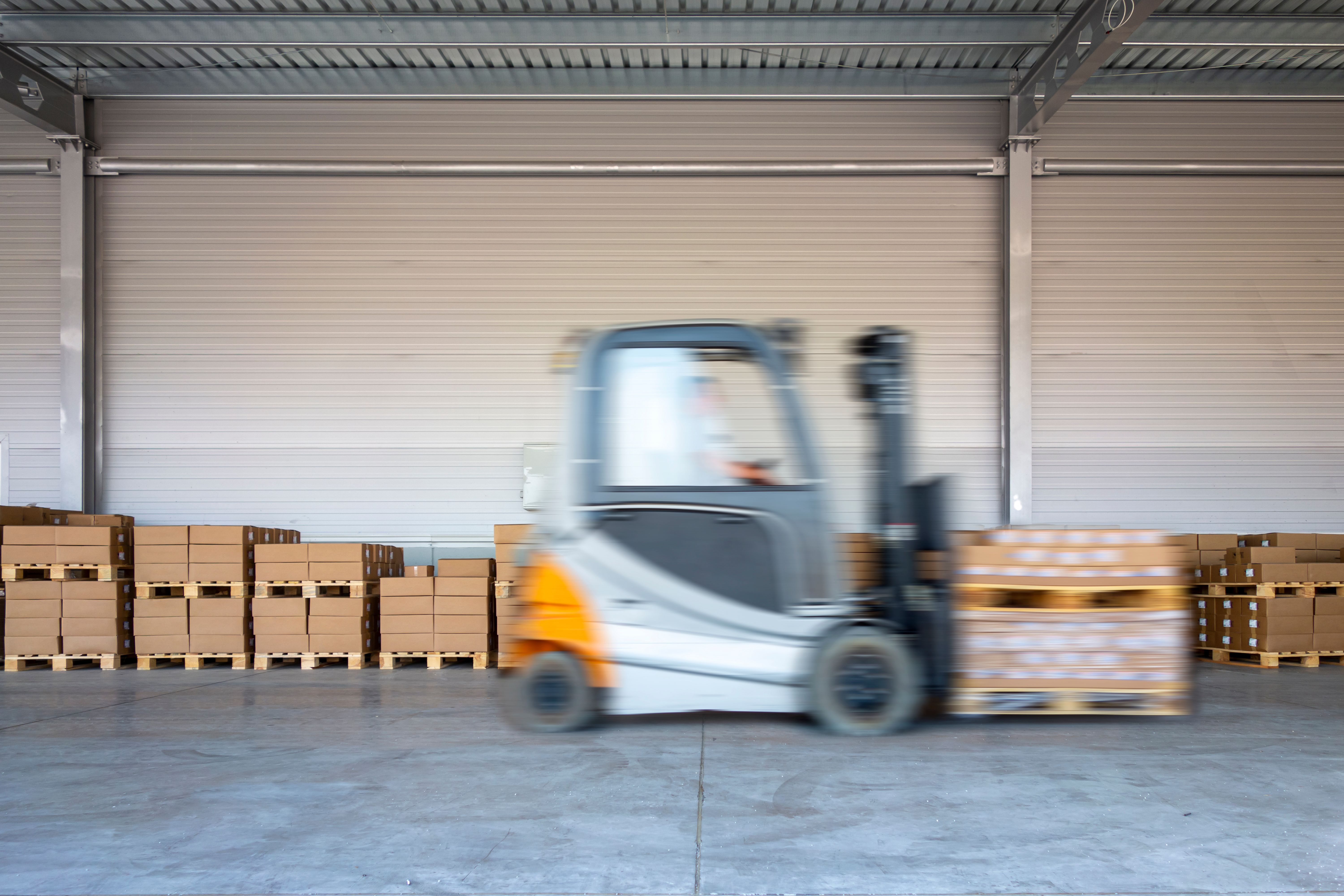 Forklift speeding across a warehouse dock