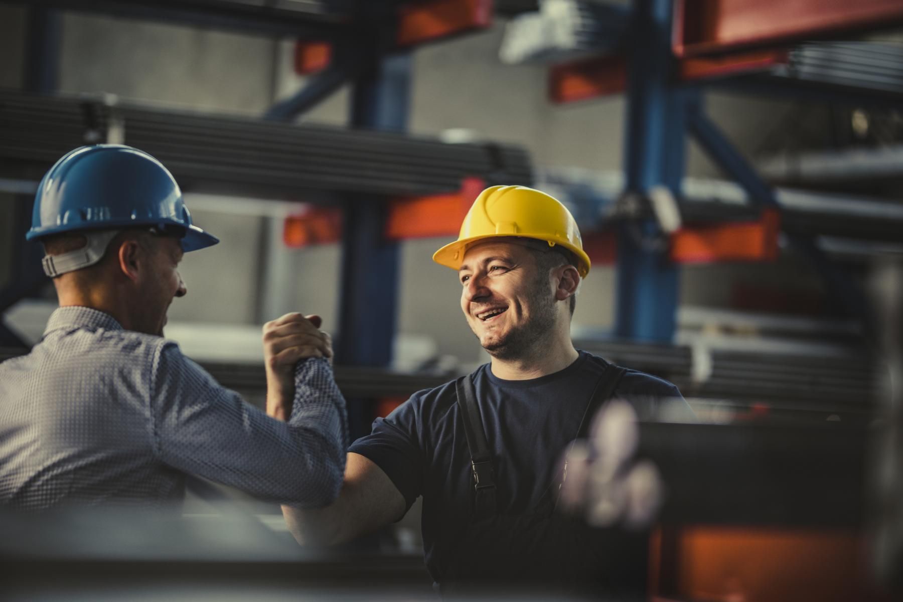 Two people handshaking in warehouse