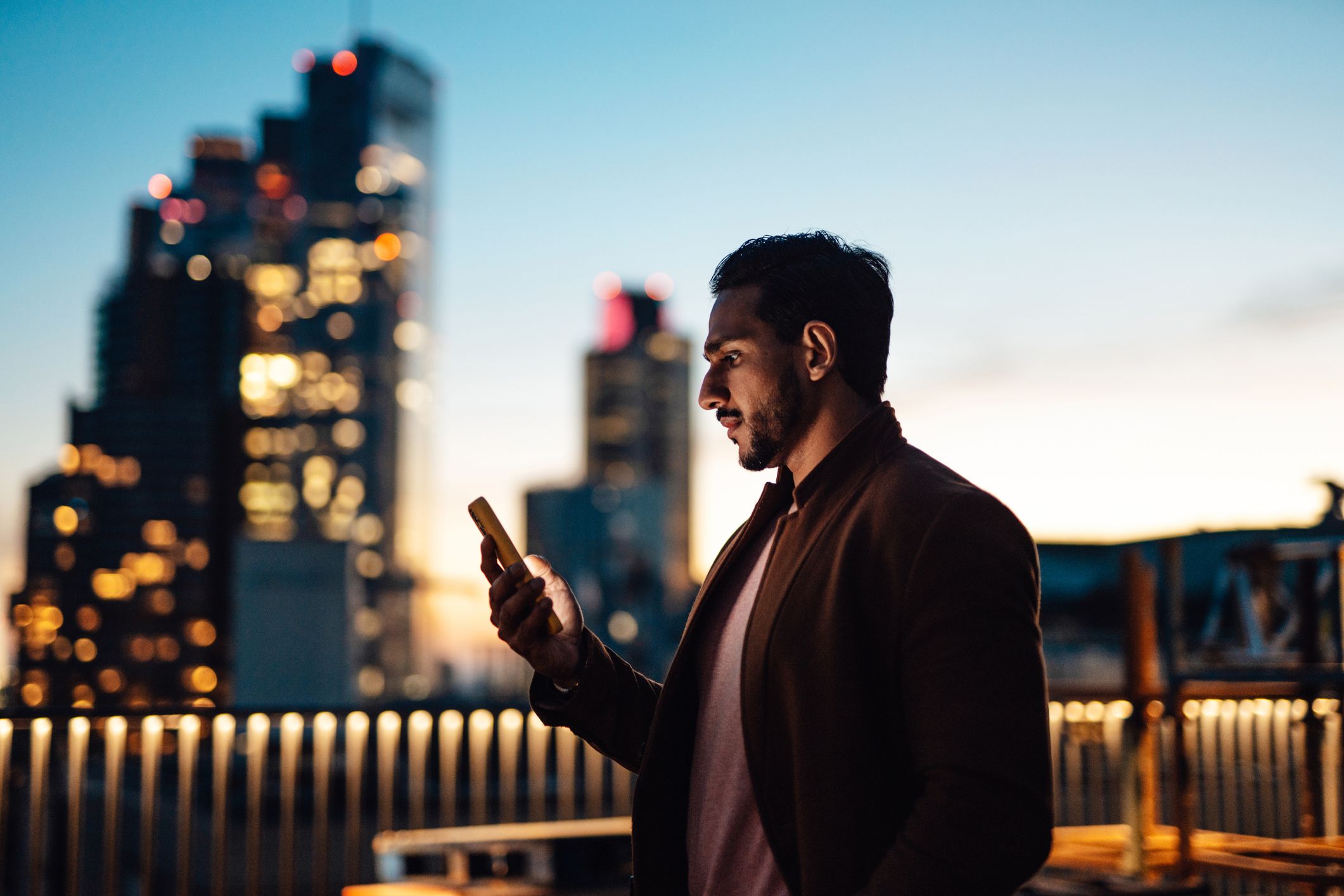 Man looking at a smartphone outside